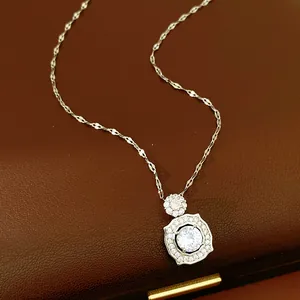 Close-up detail of silver geometric pendant necklace featuring sparkling round zircon stones