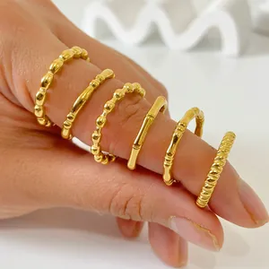 Close-up of set of six 18K gold-plated stainless steel rings with bamboo and bead textures