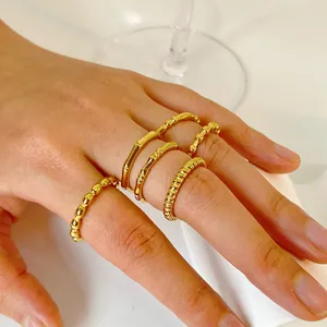 Detail shot of 18K gold plated bamboo and twisted rope rings on fingers