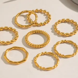 Detailed close-up of seven 18K gold-plated stainless steel rings with bamboo texture
