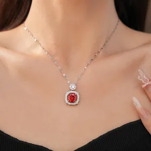 Close-up of elegant square pendant necklace with red zircon stone on model's neck