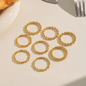 Set of eight 18K gold plated minimalist rings including bamboo and twisted link designs