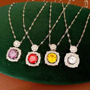 Detailed view of four zircon geometric necklaces with purple, red, yellow, and clear stones.