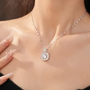 Close-up detail shot of sparkling zircon geometric pendant necklace on a model's neck area.
