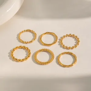 Detailed view of six-piece 18K gold plated stackable rings with bamboo and rope textures