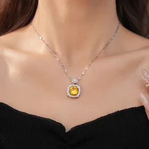 Close-up of elegant square halo necklace with a brilliant round yellow zircon stone.
