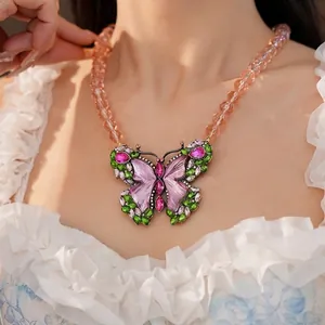 Vintage-style beaded necklace featuring a large colorful rhinestone butterfly pendant