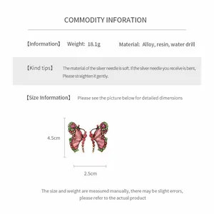 Detailed view of pink and green resin butterfly earrings with measurements