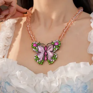 Detailed view of a vintage butterfly necklace with purple resin and colorful rhinestones