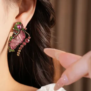 Macro view of a vintage pink resin butterfly earring with colorful rhinestones on ear