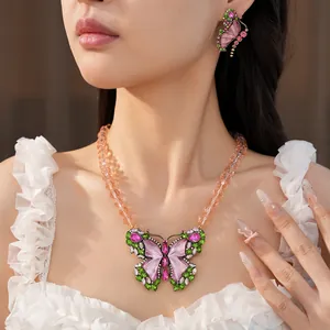 Model wearing luxury vintage beaded necklace and earrings with rhinestone resin butterfly.