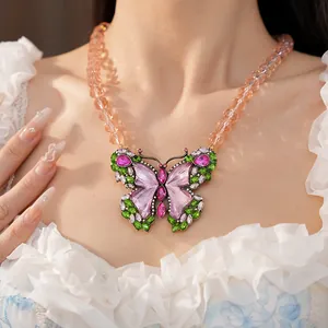 Detailed view of vintage butterfly pendant necklace with colorful rhinestones and beads.