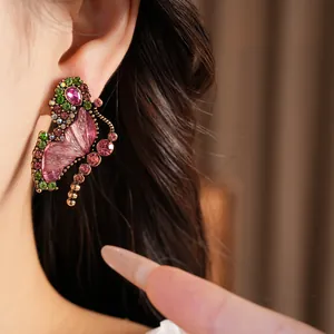 Close-up of a vintage resin butterfly earring adorned with colorful rhinestones