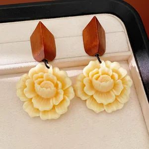 Close-up detail of elegant vintage wood and resin flower earrings with 925 silver needles