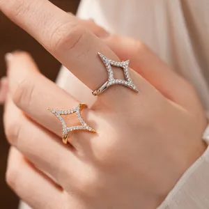 Detail close-up of 18k gold and silver plated open star rings set with sparkling zircons