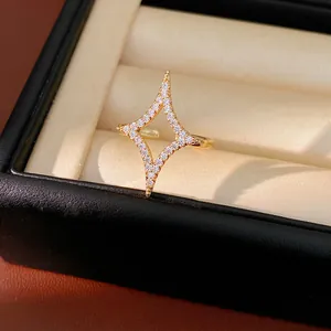 Detail view of 18k gold plated four-point star ring with sparkling zirconia in a gift box