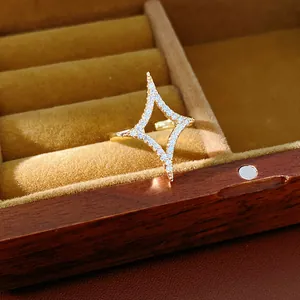 Close-up detail of 18k gold plated open ring with sparkling zircon star design