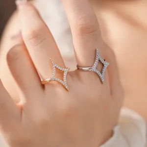 Detailed view of 18k gold plated star rings with pavé zircon settings on fingers