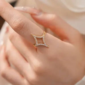 Macro view of 18k gold plated open ring featuring a zircon-encrusted four-pointed star.