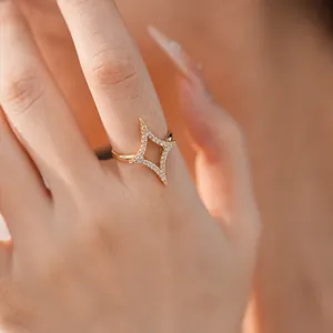 Close-up detail of 18k gold plated starburst open ring with shimmering white zircon stones.