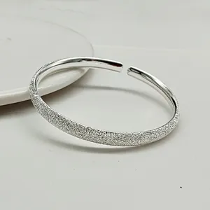Adjustable sterling silver cuff bracelet featuring polished and frosted starry finish
