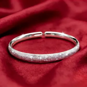 Frosted adjustable sterling silver starry bangle on luxury red velvet background
