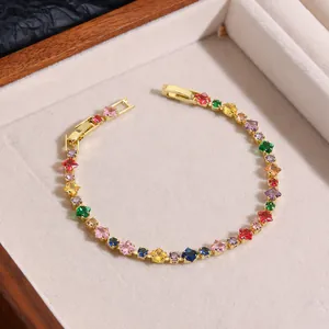 Detail of gold-plated bracelet with multi-color square-cut zircons in a jewelry box