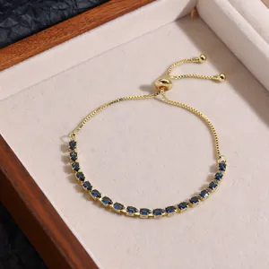 Detail of adjustable gold bracelet with sparkling navy blue marquise-cut zircon stones