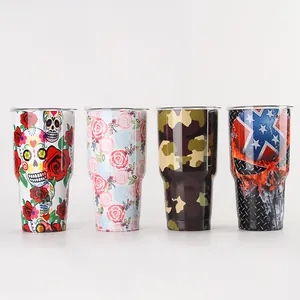Detail view of 30oz stainless steel tumblers with skull and floral printed patterns