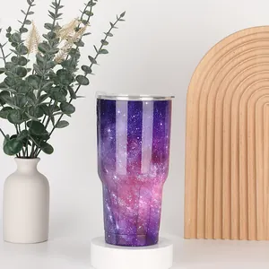 Detail of 30oz nebula pattern tumbler on display stand with modern home decor elements