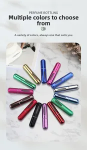 Detailed top view of multi-colored 5ml refillable perfume atomizers on marble surface
