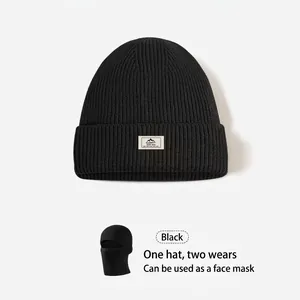 Detail of black dual-use knit balaclava beanie with woven label and mask function