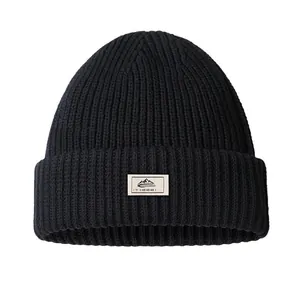 Black ribbed knit balaclava beanie with outdoor mountain patch on a white background