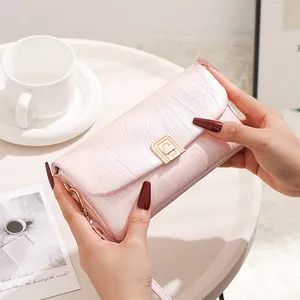 Close-up of pink wrinkled texture handbag with a gold rectangle metal swivel lock