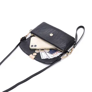 Women's multi-functional black crossbody phone bag with gold hardware and interior compartments