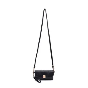 Minimalist black leather crossbody bag with adjustable strap and gold metal buckle