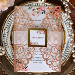 Rose gold laser-cut floral wedding invitation set with glitter finish and elegant belly band
