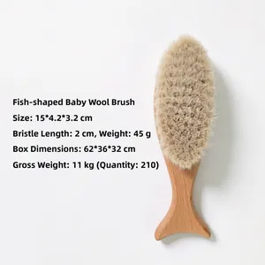 Detailed view of fish-shaped beechwood handle and soft wool bristles on baby hairbrush