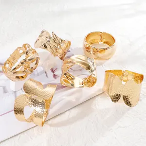 Set of six chunky gold cuff bracelets with wavy, honeycomb, and geometric textures