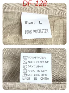 Detail of care label on beige polo shirt showing 100% polyester fabric and size L