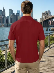 Rear view of a men's burgundy polo shirt with vertical texture on a city background