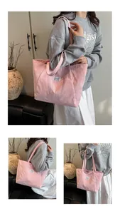 Close-up of pink corduroy tote bag featuring a retro texture and white fashion label
