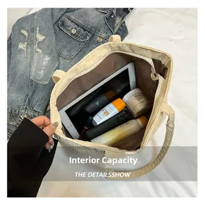 Detail view of corduroy tote bag interior showcasing large capacity and secure zipper