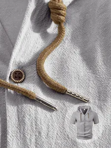Detail of light gray linen shirt fabric with wooden buttons and metallic drawstring tips