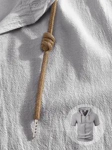Macro detail of grey linen short sleeve hoodie with woven drawstring and metal tips