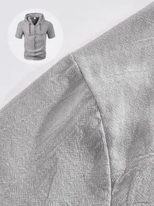 Detailed macro view of the grey linen blend fabric and shoulder stitching on hooded shirt