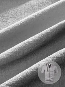 Macro detail of light gray linen fabric texture on men's hooded short sleeve shirt