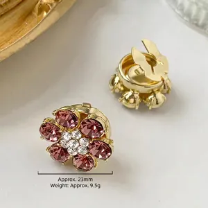 Detailed view of floral gold cufflink with purple rhinestones and size specifications