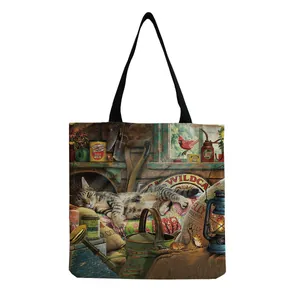 Close-up of sleeping tabby cat art print and textured canvas on a reusable tote bag
