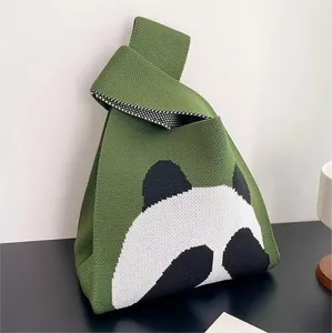 Macro detail of green knitted panda tote bag with unique knot handle and checkered lining